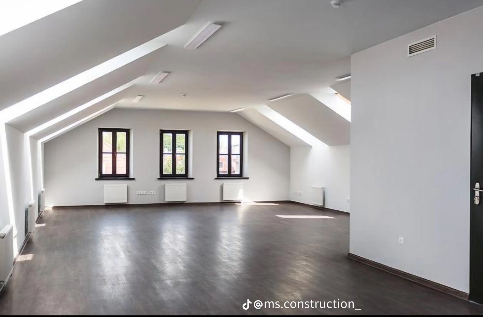 Spacious attic interior with dark flooring