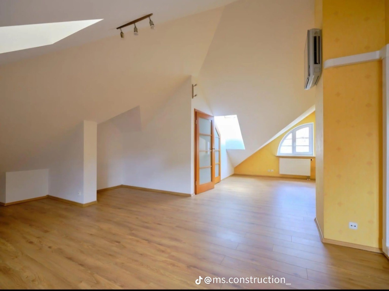 Attic interior with yellow accent wall