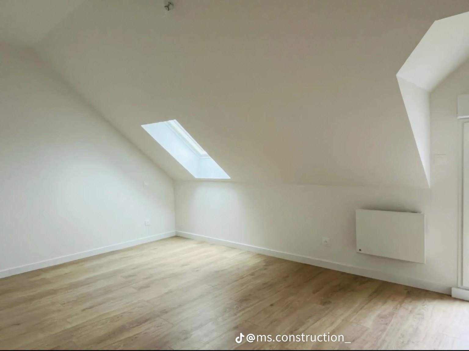 Bright attic room with roof window